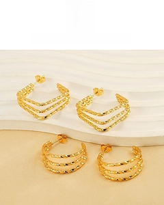 Detail of 18K gold plated stainless steel twisted earrings with geometric layers