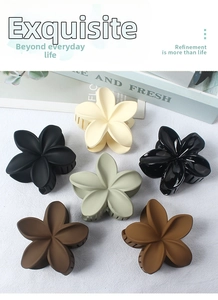 Detailed set of six floral hair claws in various colors like beige, green, and brown