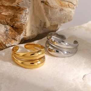 Dual-layer 18K gold plated stainless steel wave ring shown on a natural stone surface