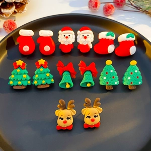 Christmas stud earrings set with festive Santa, reindeer and tree shapes on a round tray