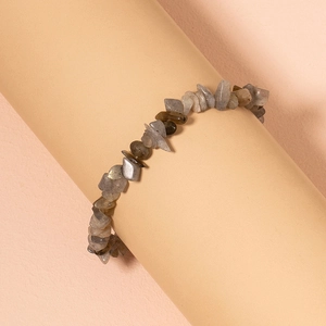 Bohemian irregular turquoise stone bracelet on soft pink minimalist display stand