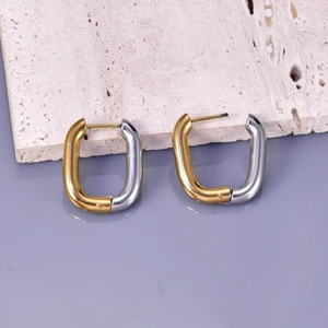 Detail of U-shaped stainless steel earrings in dual-tone gold and silver polished finish