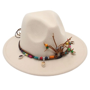 Detail of cream fedora hat with ethnic beaded leather band and bohemian ornaments