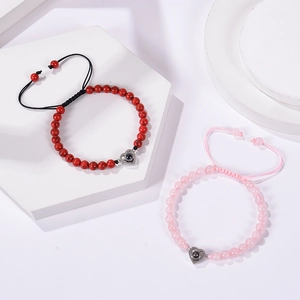 Macro shot of pink zebra stone heart beaded bracelets with 100 languages projection