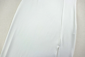 Close-up of side slit design and knitted texture on white bodycon dress for women