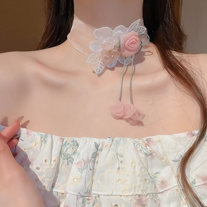Close-up of pink lace choker featuring handmade 3D roses and delicate embroidered petals