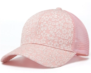 Detailed embroidery of floral lace on the brim of a pink mesh summer baseball cap