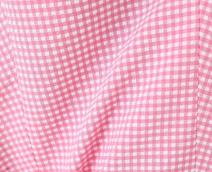 Detailed macro view of the pink and white gingham fabric texture and stitching quality