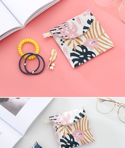 Detailed view of leaf pattern cotton storage bag with daily accessories on desk