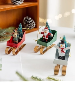 Detailed view of Nordic iron sleigh ornaments with Santa, snowman and reindeer designs