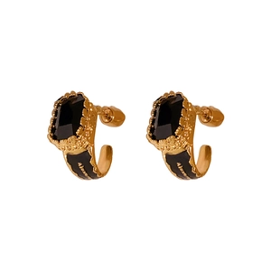Elegant gold knot earrings with black stone inlay and vintage metallic finish on white background