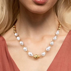 Elegant stainless steel necklace with faux pearls and irregular gold pendant on a model