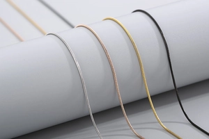 Detail of snake bone chains in silver, rose gold, gold, and black stainless steel