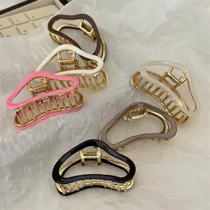 Set of minimalist cloud-shaped acetate hair claws in various colors with golden metal base
