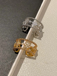 Detailed shot of gold and silver starburst rings with cubic zirconia and hollow bands