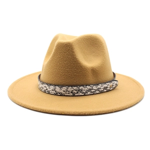 Detail of wool fedora hat in ginger yellow with a stylish snakeskin patterned band