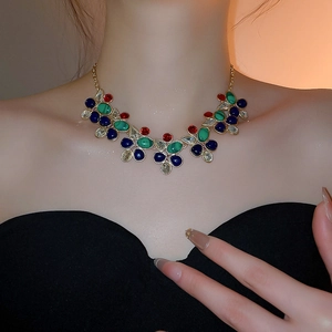Detailed view of luxury necklace with colorful drop-shaped gemstones and gold chain