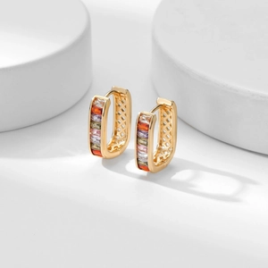 Detail of gold rectangular hoops with multi-colored zircon stones and cross hollow design