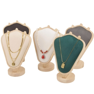 Detail of luxury velvet necklace display stands with wooden bases in various colors