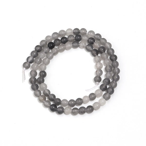 Gros plan de perles rondes en cristal gris rayé pour la création de bijoux DIY