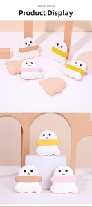 Detail view of cute ghost-shaped air cushion powder puffs with colorful cartoon faces