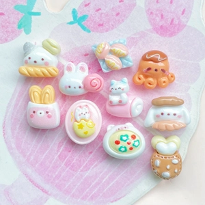 Flat lay of cute resin bear and rabbit dessert charms for DIY hair clips and crafts
