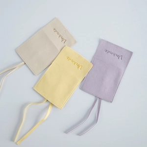 Detailed view of three colorful microfiber jewelry pouches with embossed Vinknde brand logo.