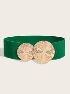 Detail of green elastic waist belt featuring gold circular metal buckles with sunray texture