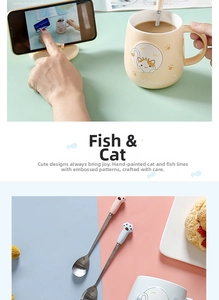Detail view of ceramic cat mug with relief kitten pattern and cute paw-shaped metal spoon