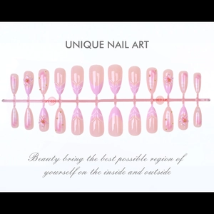 Pink press-on nails featuring 3D cherry blossoms, gold beads, and gradient French tips