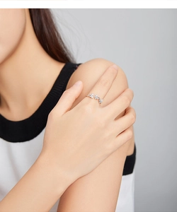 Detail of s925 silver butterfly ring featuring sparkling zircon flower inlay on fingers