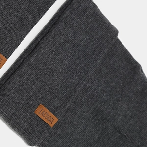 Deep grey knitted beanie featuring a brown leather patch and thick ribbed texture