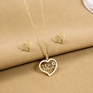 Macro shot of gold heart-shaped necklace and earrings set engraved with TE AMO MAMA text