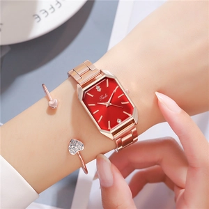 Elegant rose gold rectangular watch with red hexagonal dial and matching heart bracelet