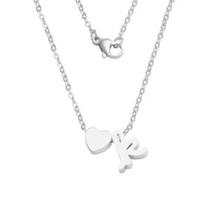 Close-up of polished silver heart and cursive letter K charms on a thin cable chain