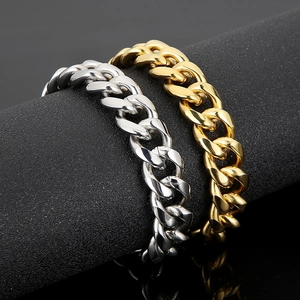 Detailed view of gold and silver stainless steel Cuban link bracelets on a display