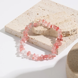 Macro shot of bohemian strawberry quartz crushed stone stretch bracelet with irregular beads