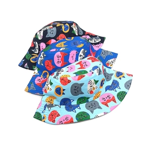 Detailed view of colorful cartoon cat prints on cotton canvas sun hats for children