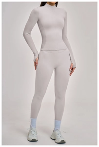 Detail of grey seamless yoga jacket featuring stand collar and thumb hole sleeve design