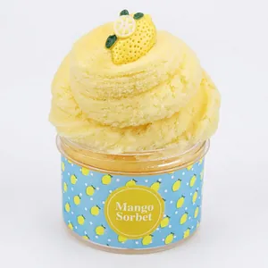 Yellow fluffy Mango Sorbet slime in a round jar with realistic fruit slices on top