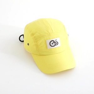 Detailed close-up of quick-dry nylon material and embroidered GO patch on yellow cap