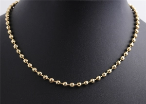 Elegant gold-plated faceted bead necklace displayed on a black bust mannequin stand