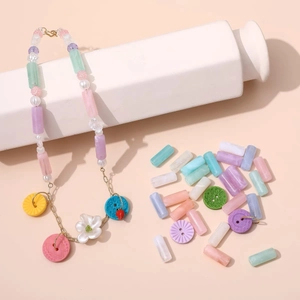 Detail of colorful acrylic cylinder beads and white pearls for DIY jewelry making