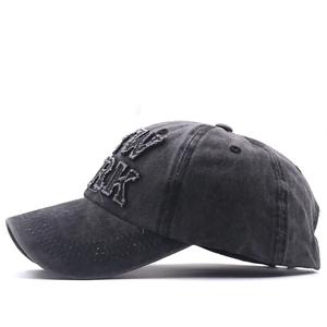 Detail of dark gray washed cotton baseball cap with New York embroidery and frayed edges