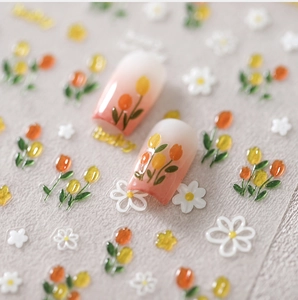 Macro detail of 3D embossed tulip and daisy nail stickers with Lucky lettering