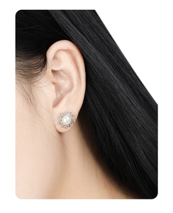 Macro view of irregular lava style S925 silver stud earrings with natural pearls