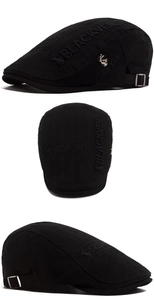 Detail of black cotton ivy cap featuring 3D embroidery and metal deer pin ornament