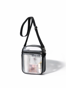 Macro view of clear PVC crossbody bag with black trim and silver zipper hardware details