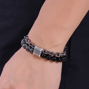 Detail of men's double-layer bracelet with black lava beads and stainless steel chain