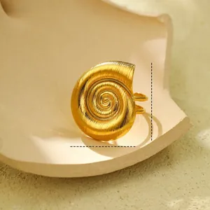 Macro detail of gold spiral conch shell ring showing 2.7cm height and brushed texture